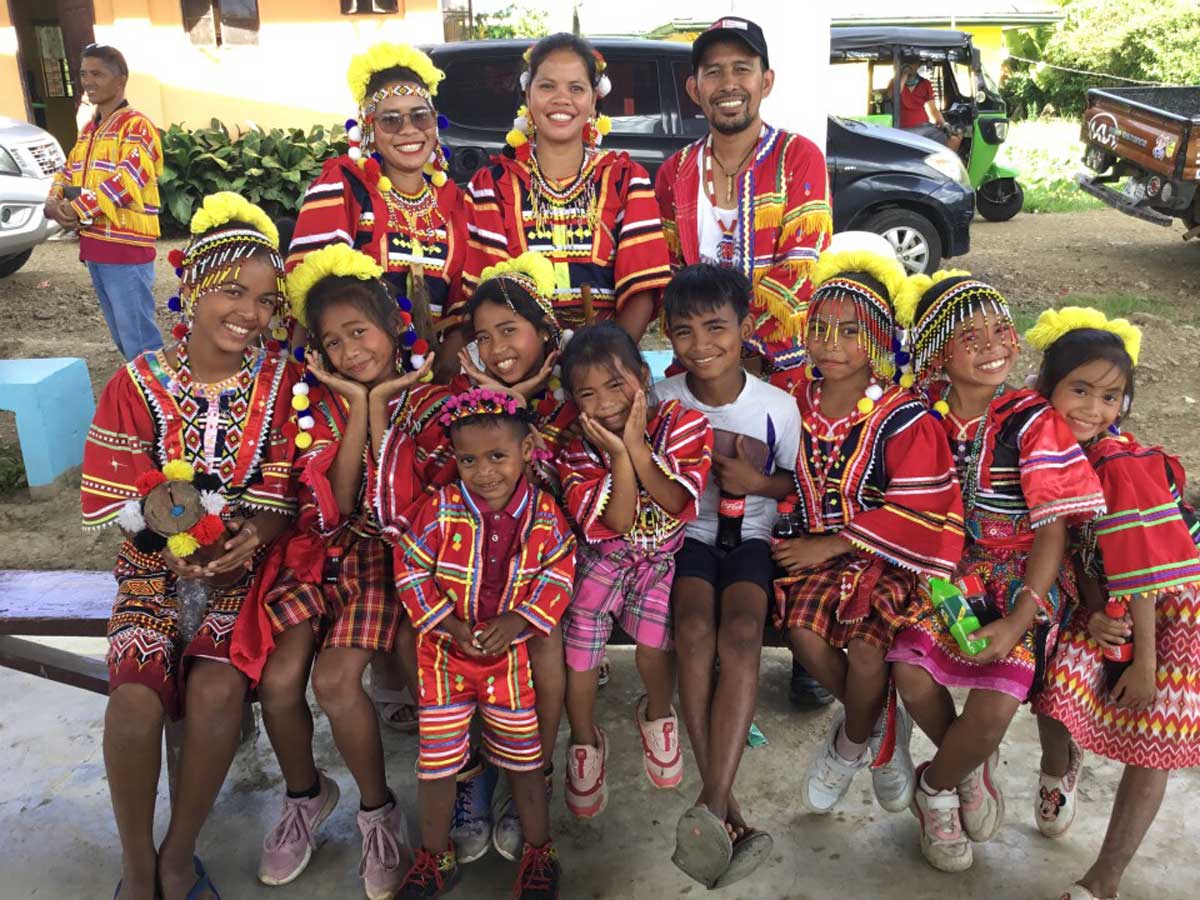 Happy Matigsalug group wearing traditional local dress.